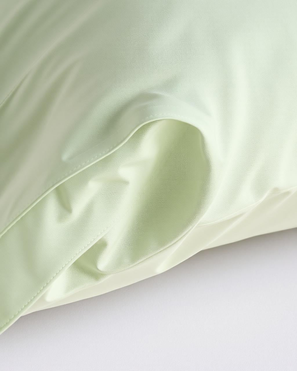 Close-up percale sage pillowcase envelope closure